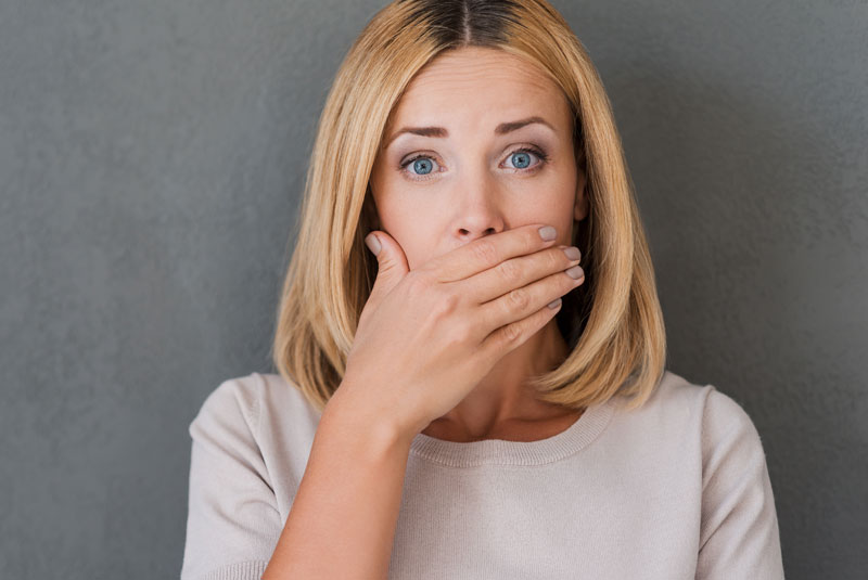 Dental Patient Covering Her Mouth