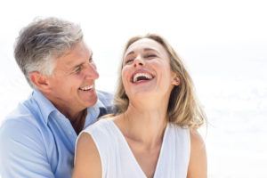 Two Dental Implant Patients Smiling Together After Their Dental Implant Procedure