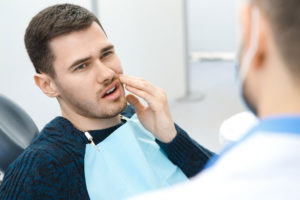 Dental Patient Suffering From Mouth Pain On A Dental Chair, In Woodbury, MN