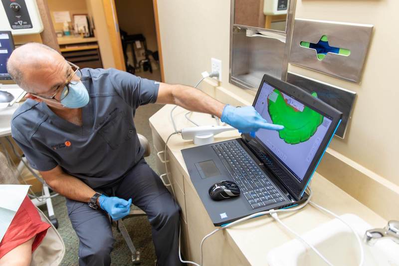 Dr. Wilhelm with his patient during a dental implants consultation
