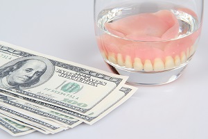 cash and dentures in a glass
