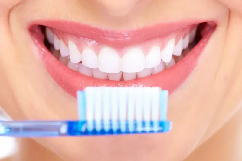 Bright white smile beside a toothbrush