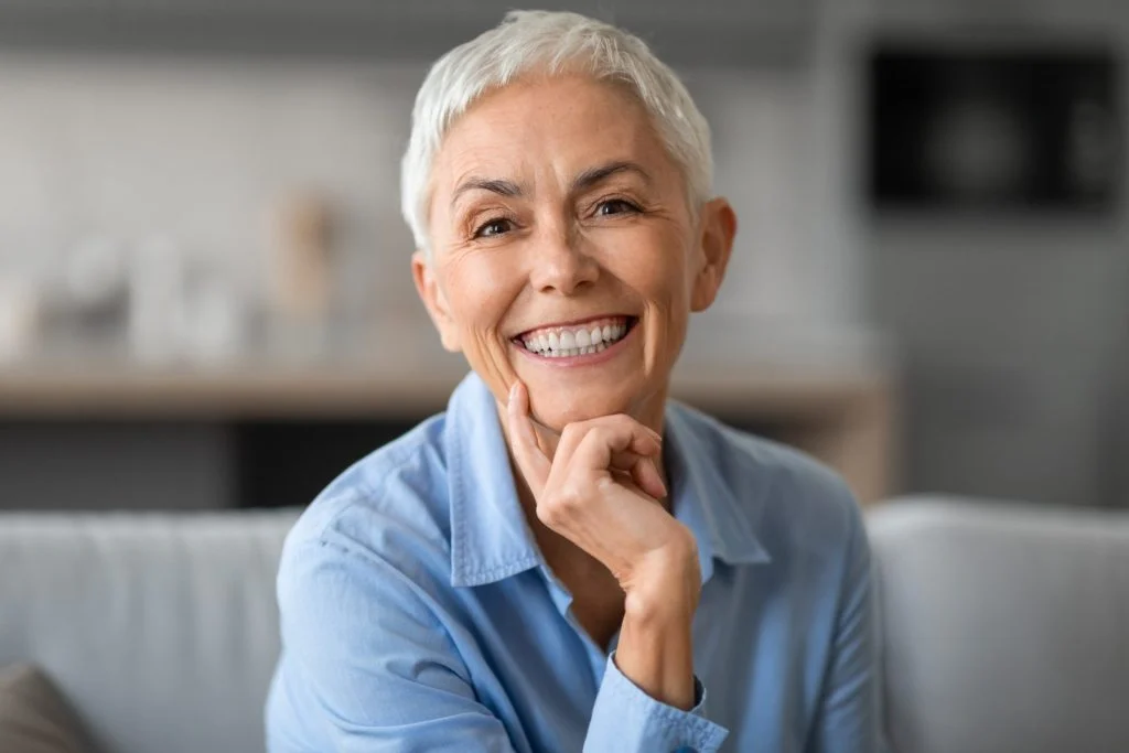 portrait lovely older woman smiling camera touching chin