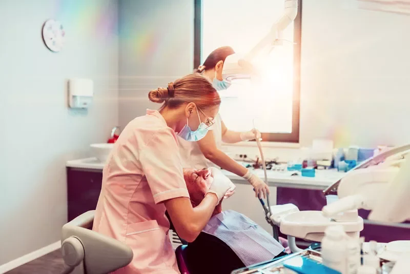 two nurses with an implant patient